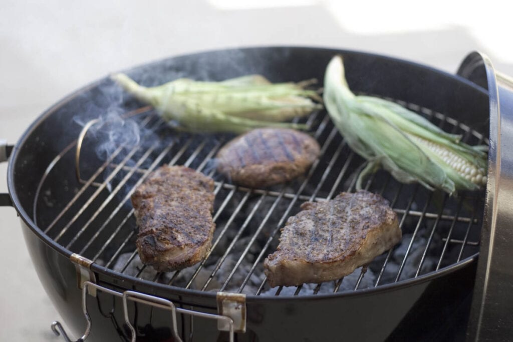 burgers and corn cob on the grill