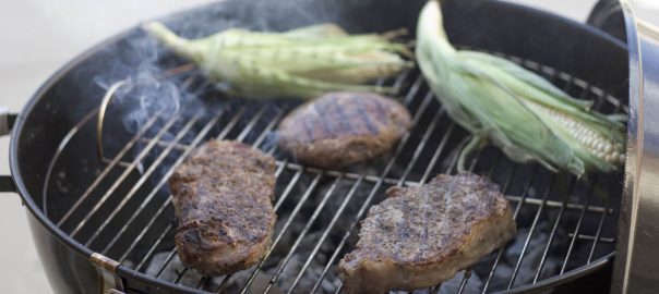 burgers and corn cob on the grill