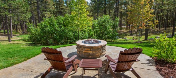 two deck chairs in front of outdoor firepit