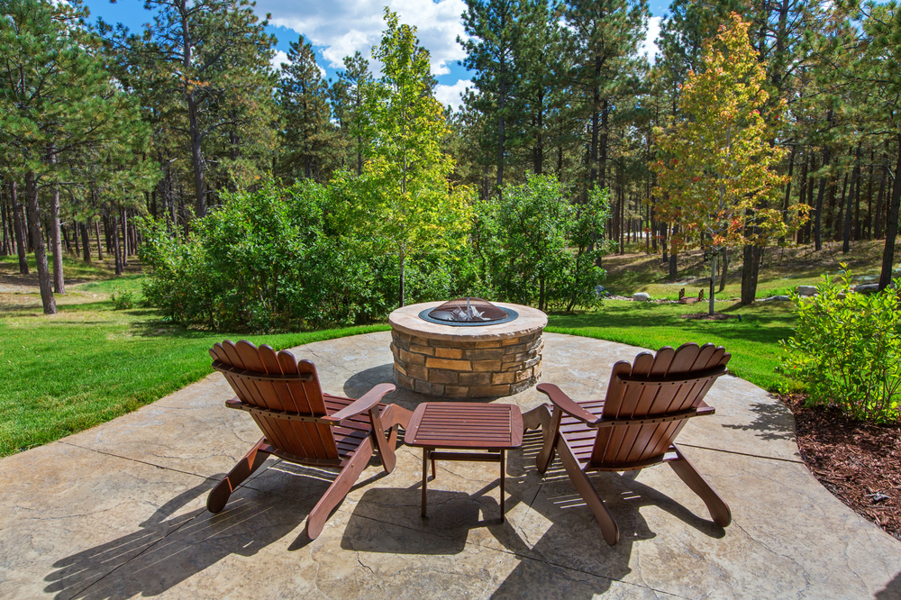 two deck chairs in front of outdoor firepit