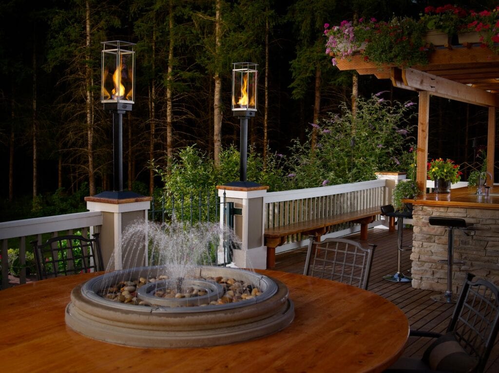 lighting poles on patio around tabletop fountain