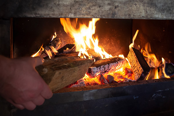 wood being added to a wood stove