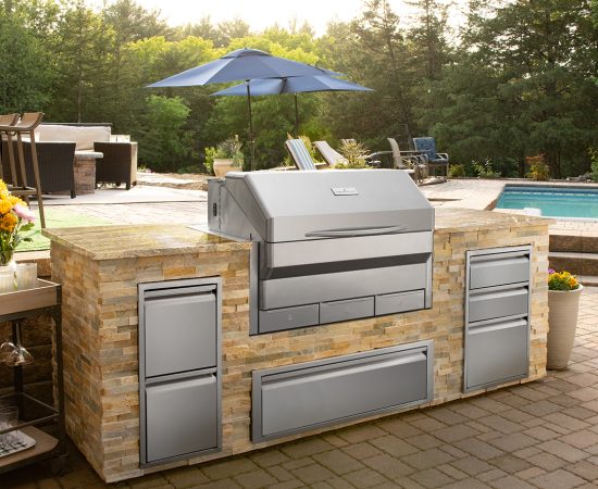 Built-in Memphis Wood-Fire Pellet Grill on a medium-size outdoor kitchen island/bar