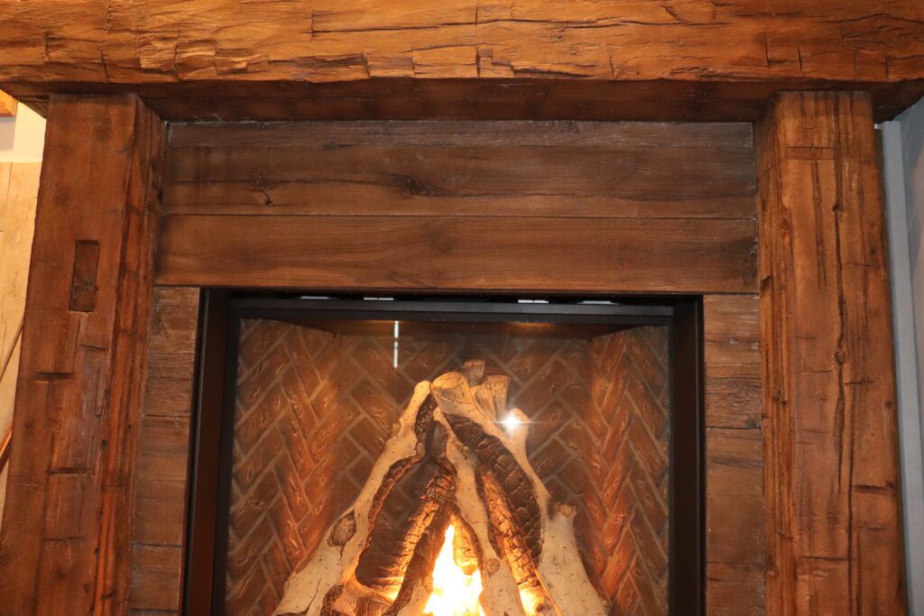 An image of a brown wooden mantel over a fireplace.